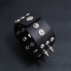 Macro shot of punk leather bracelet with polished silver studs and sharp metal spikes