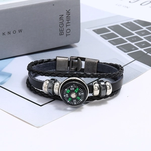 Close-up of leather multilayer braided bracelet featuring a functional compass and metal beads
