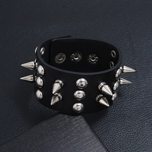 Macro view of punk black leather cuff bracelet with silver metal spikes and studs
