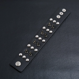 Punk leather bracelet with silver metal spikes and adjustable button clasp for wrist wear