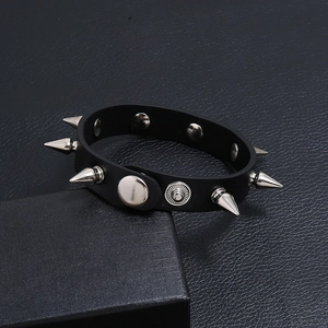 Punk black leather bracelet featuring silver cone studs and metal snap button closure