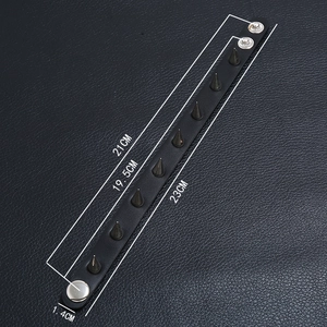 Detail view of punk black leather bracelet with eight sharp metal spikes and snap buttons