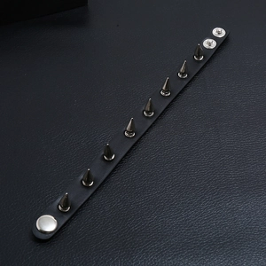 Punk black leather bracelet with nine gunmetal cone studs and snap fasteners
