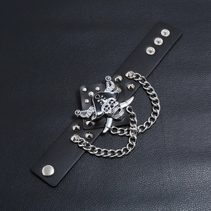 Detail of punk leather bracelet featuring silver skull, chains and metal rivets