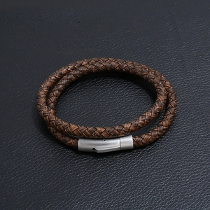 Close-up of brown double-wrap braided leather bracelet with brushed steel clasp