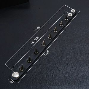 Detail view of punk black leather rivet bracelet showing adjustable metal snap buttons
