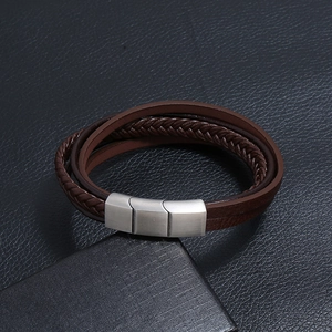 Detail view of multi-layer brown braided leather bracelet with silver magnetic metal clasp