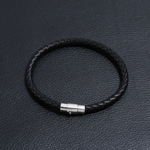 Close-up of black braided leather bracelet with polished silver magnetic steel clasp