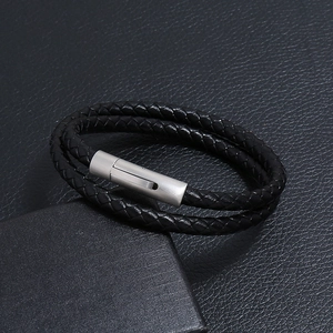 Close-up of black braided double-layer leather bracelet with matte silver metal clasp