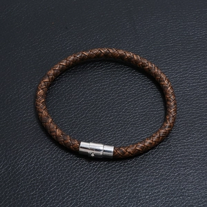Detailed view of dark brown braided leather bracelet with silver magnetic metal clasp