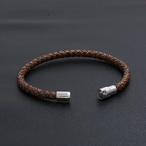 Handmade brown braided leather bracelet for men featuring a vintage silver metal clasp