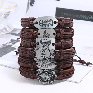 Brown multilayer braided leather bracelet set with retro alloy animal charms on white background
