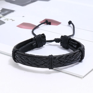 Close-up of woven black leather bracelets featuring a multi-layer punk wrap style