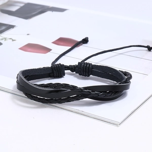 Detail view of black multi-layer woven leather bracelet with adjustable drawstring closure