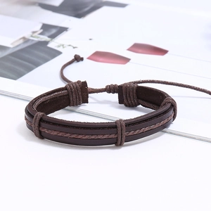 Detail of dark brown multi-layer leather bracelet with adjustable woven pull-string knot