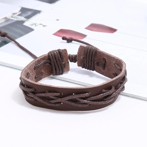 Detail of dark brown braided leather bracelet with adjustable cord closure and vintage style