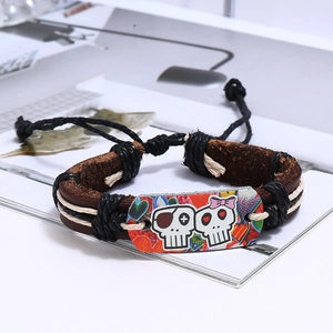 Detail of multi-layer leather bracelet featuring punk skull charms and braided rope textures