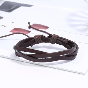 Detail of dark brown braided leather multilayer bracelet with adjustable cord closure
