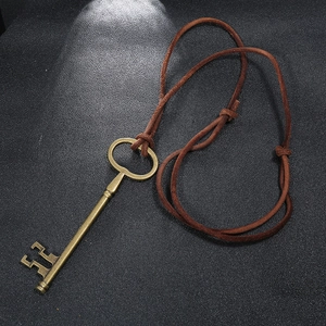 Vintage bronze key pendant necklace for men featuring adjustable brown leather cord