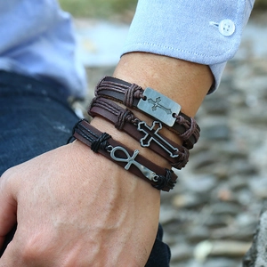 Vintage braided leather bracelet set for men with cross and ankh pendants on wrist