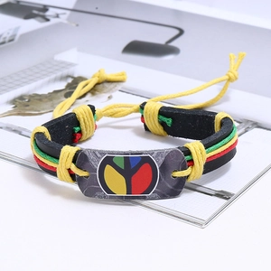 Detail of woven leather bracelet with hippie peace sign and colorful ethnic rope bands