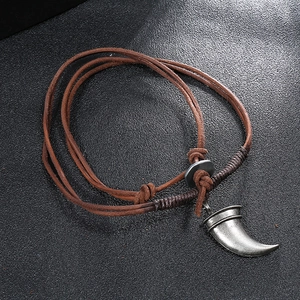 Retro brown braided leather necklace for men featuring a vintage silver tusk pendant
