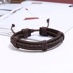 Detail of the dark brown woven multi-layer leather bracelet with adjustable knot closure