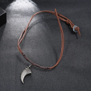 Retro men's woven leather necklace featuring a silver metallic wolf tooth pendant on black