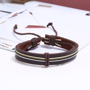 Close-up of vintage multi-layer leather bracelet set with woven cords and pull-string closure