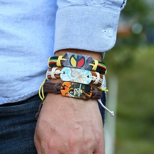 Men's vintage braided leather bracelet set with peace sign and pirate skull charms