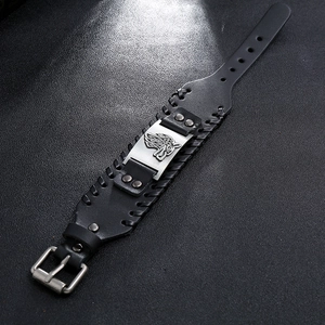 Macro detail of Nordic Viking leather bracelet featuring a silver wolf head totem and buckle