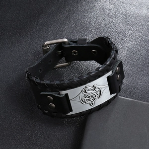 Détail d'un bracelet en cuir tressé pour homme avec plaque métallique de dragon celtique