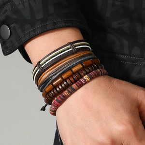 Macro shot of 5-piece Bohemian set featuring braided leather, wood beads and ethnic cords