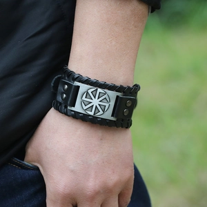 Vintage braided black leather cuff bracelet with metal Slavic Kolovrat sun wheel symbol