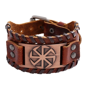Vintage brown braided leather bracelet with copper Kolovrat sun wheel symbol and buckle