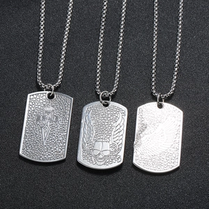 Detail of punk style dog tag necklaces with embossed sword, skull and wing motifs