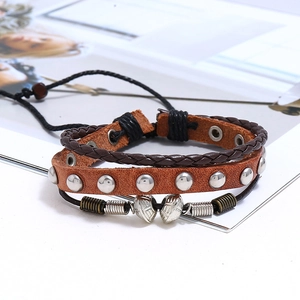 Detail of multi-layer vintage leather bracelet with silver studs and alloy beads set