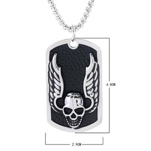 Close-up of punk dog tag pendant with skull and wings design on box chain necklace