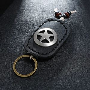 Handmade leather star keychain with woven rope and vintage brass ring accessory