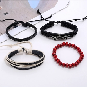 Detail of four-piece men's bracelet set with leather, silver motorcycle charm and wood beads