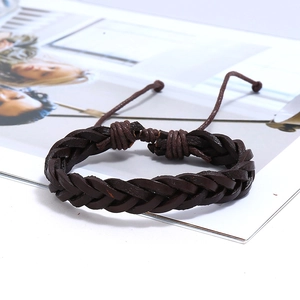 Detailed macro view of dark brown braided leather bracelet with adjustable drawstring closure