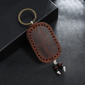 Handmade vintage double-layer brown leather keychain with orange stitching and tassels