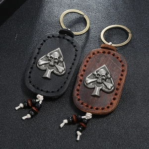 Vintage leather keychains in black and brown with skull metal charm and beaded cord