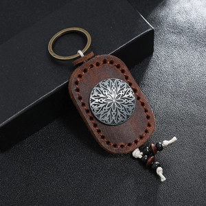 Vintage brown leather keychain with engraved metal ornament and wooden beads charm