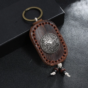 Handmade leather keychain with dragon relief carving and bronze ring for bags