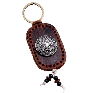 Retro handmade brown leather keychain with silver dragon emblem and red stitching