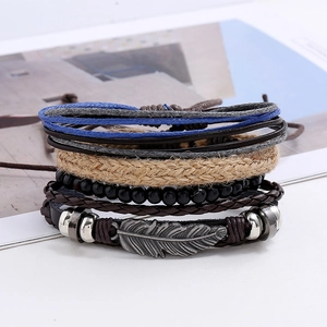 Detailed macro view of multi-layer leather bracelet with silver feather charm and woven ropes