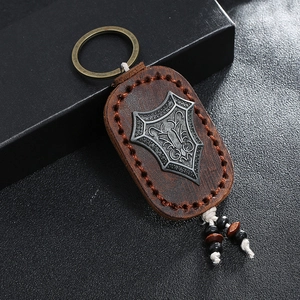 Handmade leather keychain with vintage shield crest and stitched brown cowhide leather