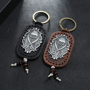 Vintage leather skull keychains with metal pirate charms in black and brown colors