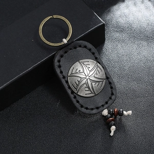 Handmade vintage leather keychain with starburst silver emblem and wooden beads